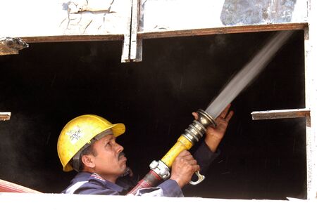 KARACHI/PAKISTAN_ After math Pakistani fire fighter cleaning up Pakistani movies house Prince Cinema house yesterday Pakistani protester burnt down movies during protest Anti Islam film made in USA  in Karachi   22 sEPT. 2012     のeditorial素材