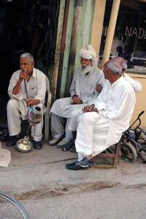 KARACHI/PAKISTAN_ Pakistani struggle for daily life male own Wafash cycle works and senior smoking water pipe ,since sneior has no plce to go in their free time there are no senior home, most  of senior spend time on shop or in street Azam basti 26 Sept. のeditorial素材