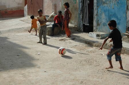 PAKISTAN_KARACHI_pakistani christian children playing cricket on street in karachi. sept,26,2012のeditorial素材