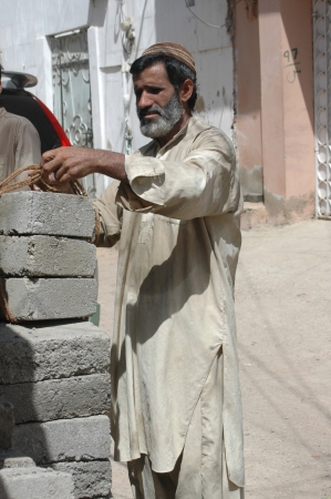 KARACHI/PAKISTAN_ Pakistani bricks  labour workers caryy heavy bricks to make daily living 7 Oct. 2012      のeditorial素材