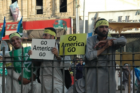 KARACHI/PAKISTAN_ Supporters of thr Jamaate-e-islami  staged proetst rally against USA and anti islam film ,film made in usa  and walked on USA flag star and stripes and burt usa flags in Karachi tdoay with banner Go America Go , 7 October 2012       のeditorial素材