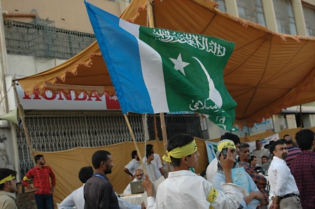 KARACHI/PAKISTAN_ Supporters of thr Jamaate-e-islami  staged proetst rally against USA and anti islam film ,film made in usa  and walked on USA flag star and stripes and burt usa flags in Karachi tdoay with banner Go America Go , 7 October 2012       のeditorial素材