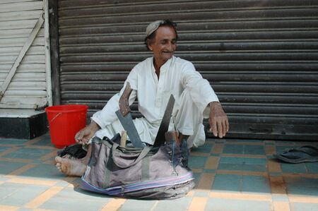 KARACHI/PAKISTAN_ Pakistani jobless males waiting for empolyers come and give them daily job  since Pakistani people do not much seek job thorugh job center 3 Nov. 2012      のeditorial素材