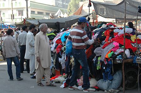 KARACHI/PAKISTAN_ Pakistani 2nd hand shoppers at 2nd hand bazar shopping 2nd hand cloths for winter at half price 26 Nov. 2012      のeditorial素材