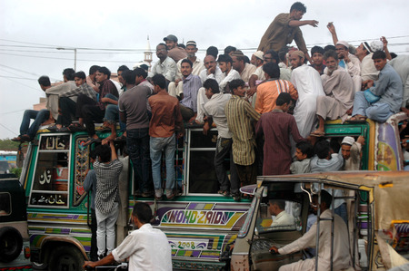 Karachi /Pakistan- Pakistani spend most of time during transport to work and from work to home there is bus shortage in Pakistan there is no bubic bus system and most fo the time people have to find place on busroofs which is dangerous and people of Pakisのeditorial素材