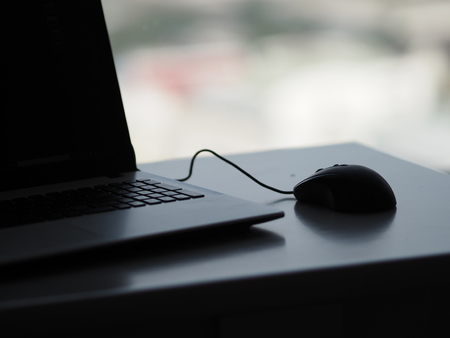 notebook and mouse on desk space for writeの写真素材