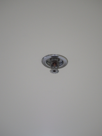 fire sprinkler heater on white ceilingの写真素材