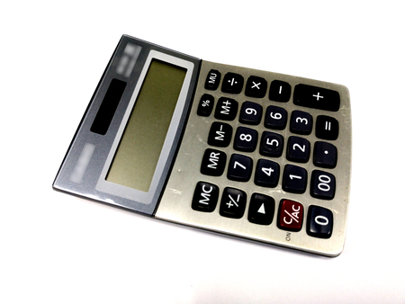 old calculator on white background  office equipmentの写真素材