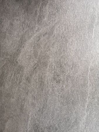 Black stone rough surface texture material hard gray color background wallの写真素材