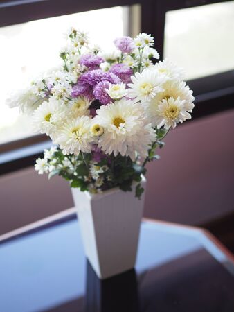Gerbera Flower purple and white color beautiful bouquet in white ceramic bottleの写真素材