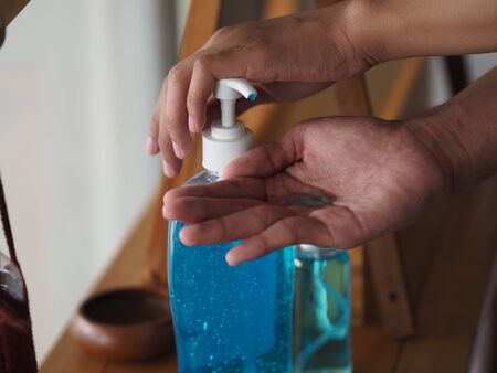 Together child boy squeezing gel on finger hand the gel alcoholic 70 percent mixture with gelatin to...