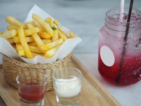 French fries potato snack golden yellow color Delicious crisp in wicker basket and Red Sodaの写真素材