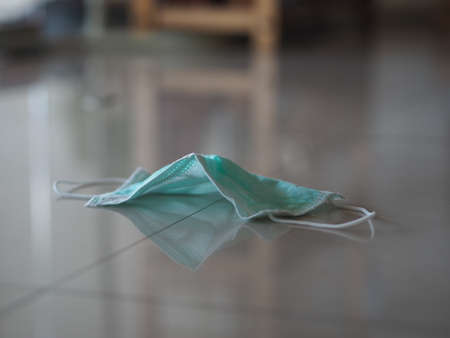 Used disposable face mask on the floor self prevention ill for protect dust and germs pm 2.5, coronavirus covid-19の写真素材