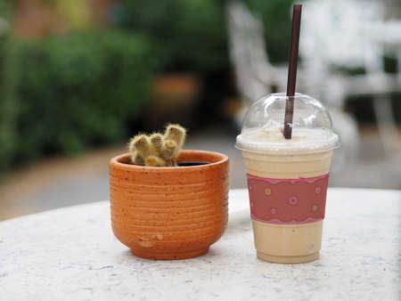 Cappuccino smoothie in a clear plastic glass on marble table, coffee cold drinkの写真素材