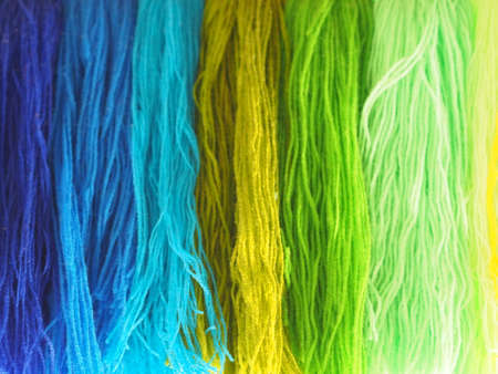 Yarn, Garn several colors arranged abstract Gradient for background, colorful yellow green blue purple violet gold dark and soft color, cool toneの写真素材