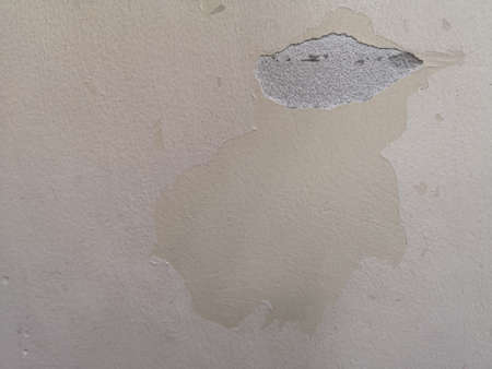 Crack and color slips off Cement wall plaster, spread on concrete polished textured background...