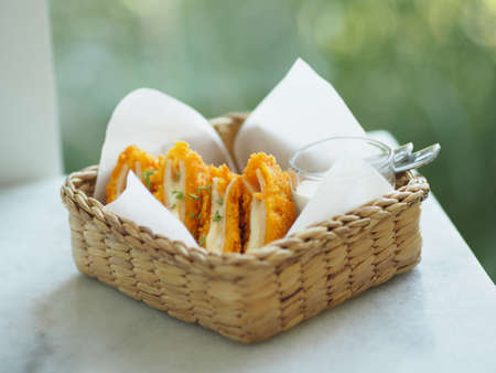 Chicken Cordon Bleu in Wicker basket, food on tableの写真素材