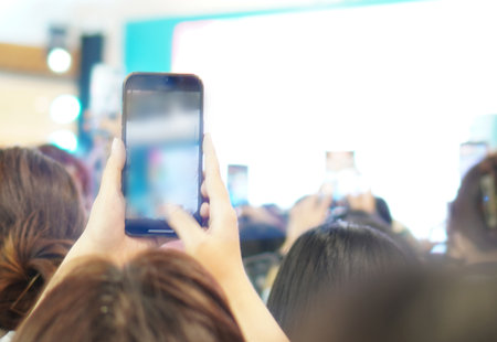 blurred woman take photo from smartphoneの写真素材