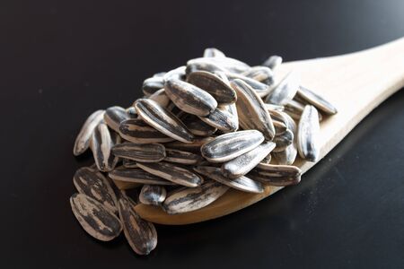 Sunflower seed on wooden spoonの写真素材