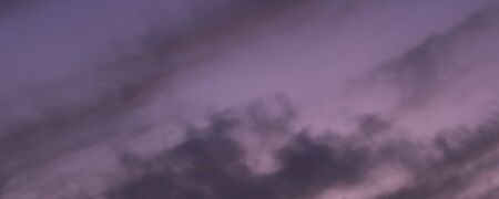 Great sky with sunset clouds all possible shades of pink and purple, big nature background.の写真素材