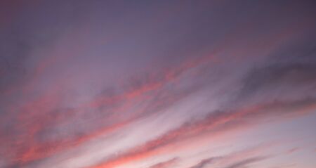 Great sky with sunset clouds all possible shades of pink and purple, big nature background.の写真素材