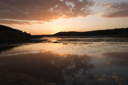 Swamp of Negratin in the province of Granada (Spain) at golden hour with cloudsの写真素材