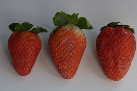 three strawberries isolated on white backgroundの写真素材