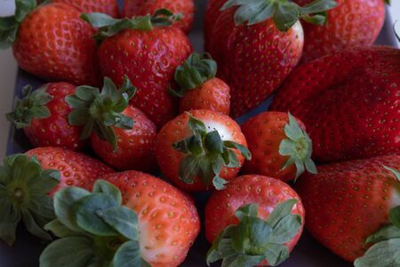 Strawberries on gray ceramic plate. vertical planeの写真素材