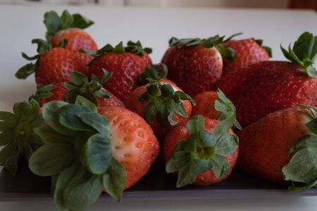 Strawberries on gray ceramic plate. horizontal planeの写真素材