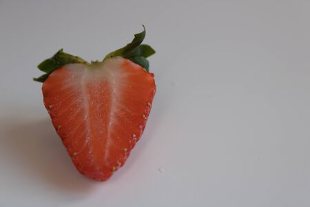 strawberry cut in half isolated on white backgroundの写真素材