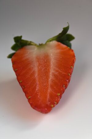 strawberry cut in half isolated on white backgroundの写真素材