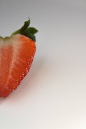 strawberry cut in half isolated on white backgroundの写真素材