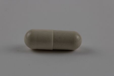 white pill capsule isolated on white background. photography of medicinal productsの写真素材