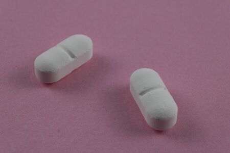 Close up view of medicine on pink surface. photography of medicinal productsの写真素材
