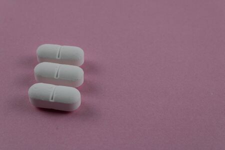 Close-up of the medicine on the pink surface with space on the right for text. photography of medicinal productsの写真素材