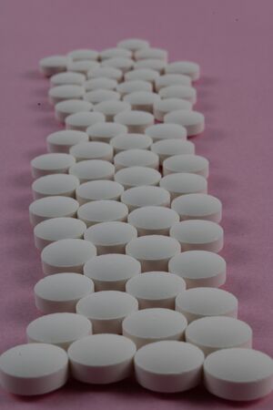 pink bottom tablet set. photography of medicinal productsの写真素材