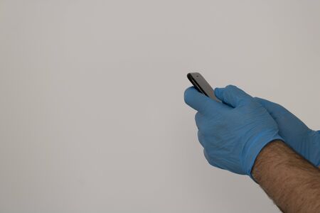 hand with gloves and mobileの写真素材