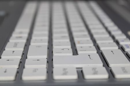 grey laptop keyboard with white keysの写真素材