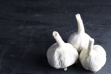 group of three heads of garlic with black background. dark foodの写真素材