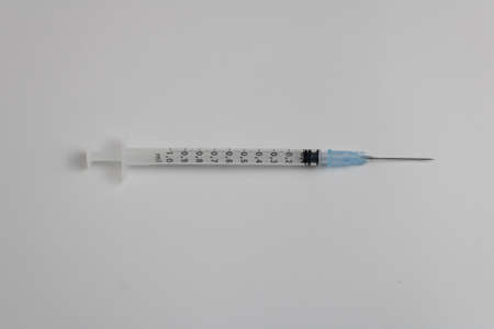 syringe with needle with blue medicine isolated on white backgroundの写真素材
