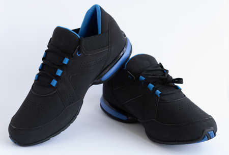 blue and black insulated leather sneakers on a white backgroundの写真素材