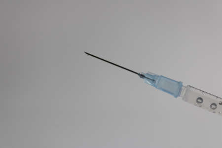 Syringe needle with a drop of medicine at the tipの写真素材
