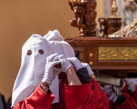 Nazarene in the procession of Holy Week carrying Jesus Christ