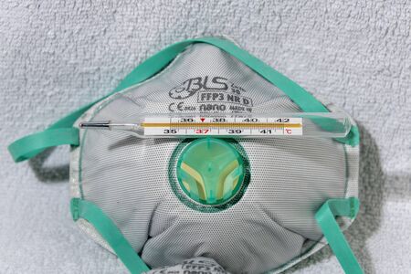 Virus and nanoparticle protection mask with a thermometer on top