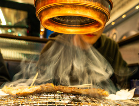 Pork belly with smoke over a charcoal grillの写真素材
