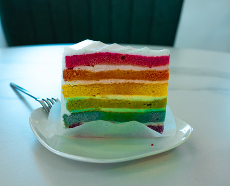 Fresh baked homemade Rainbow cake set on table.