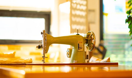 A vintage manual sewing machine on an old wooden table