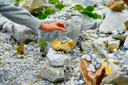 Relaxed spiritually childs hand arrangement pebble tower. Yoga relax meditationの写真素材