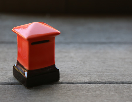 A small mailbox cabinet, on a wooden floor.の写真素材