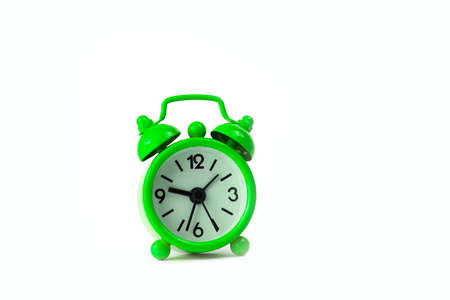 Small green clock on white background.